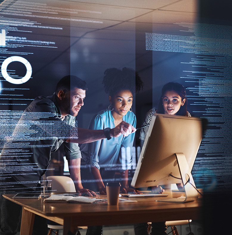 Three people in front of desktop screen