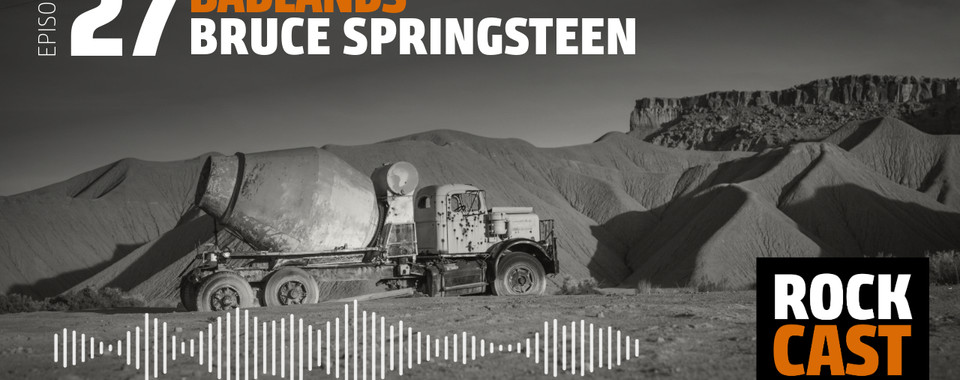 A neglected concrete mixer in the desert. Overlay text reads "Episode 27 Badlands Bruce Springsteen."